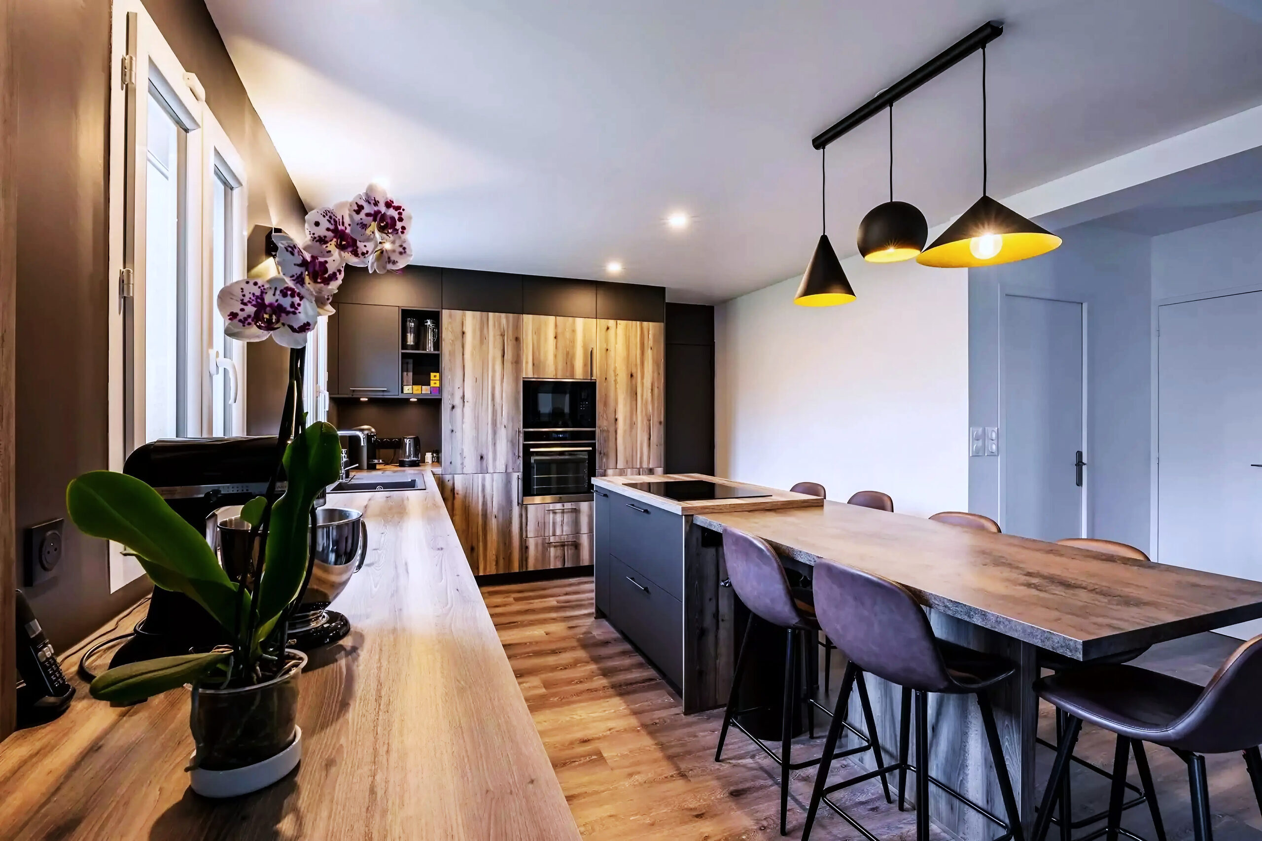 Cuisine Nordique : le mobilier haut est regroupé au fond, tandis que le plan longe les fenêtres.
